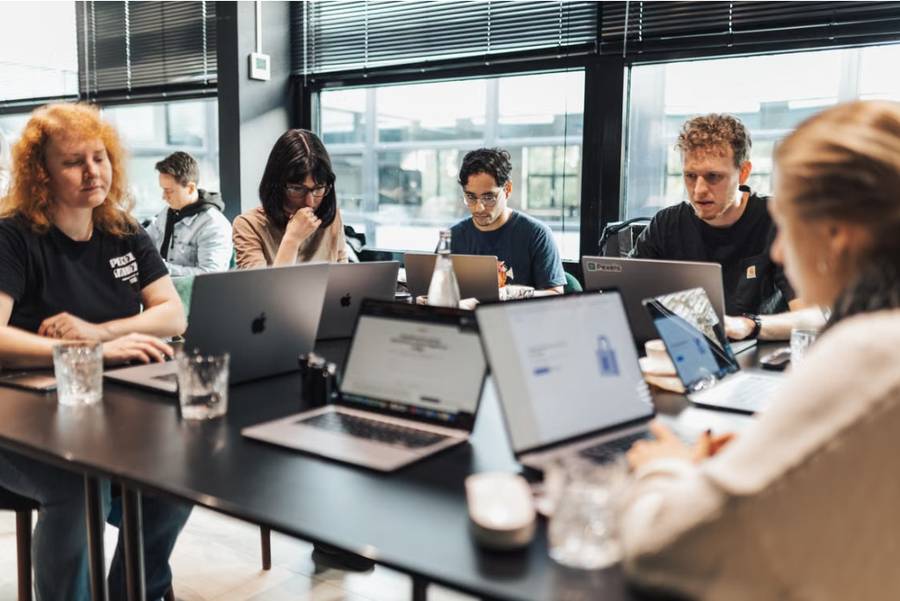 Participants working on laptops during an AI workshop session